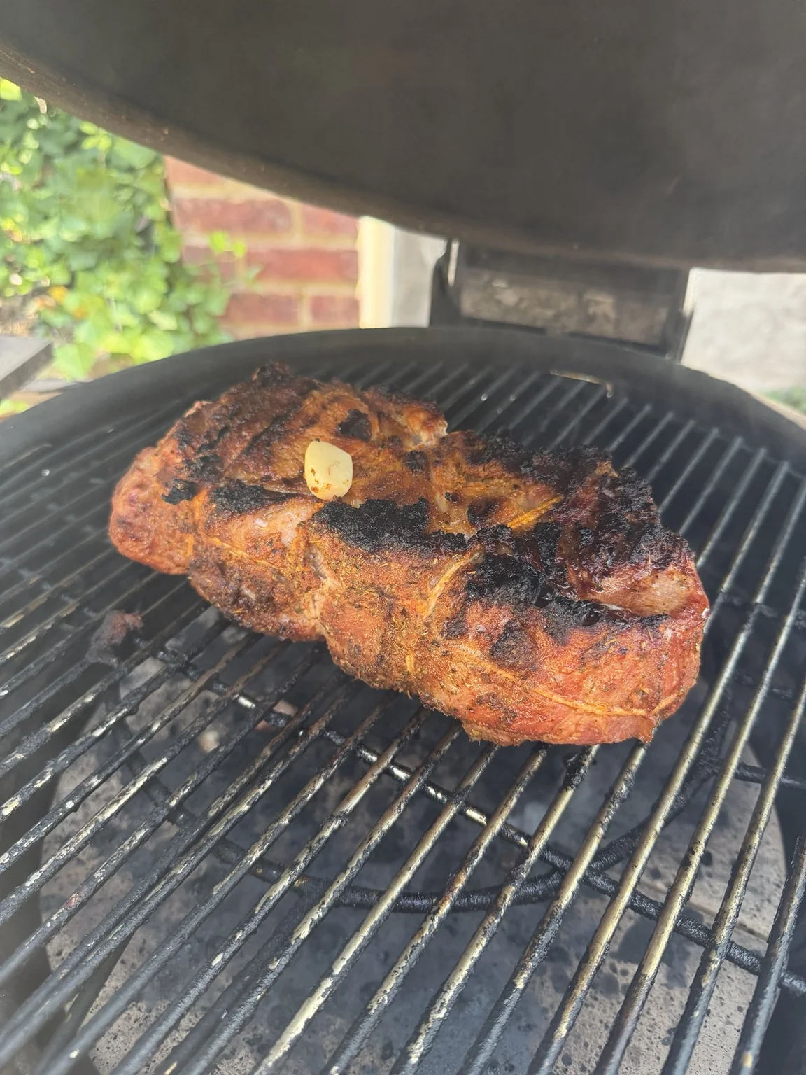 The roast developing a dark crust on the grill.