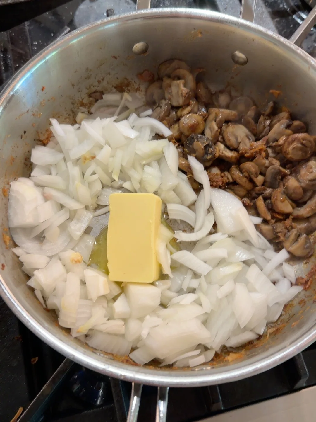 Onions and mushrooms going into the pan.