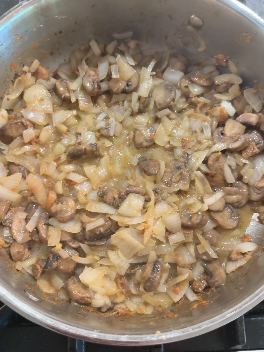 Onions and mushrooms softened before the tomato stage.