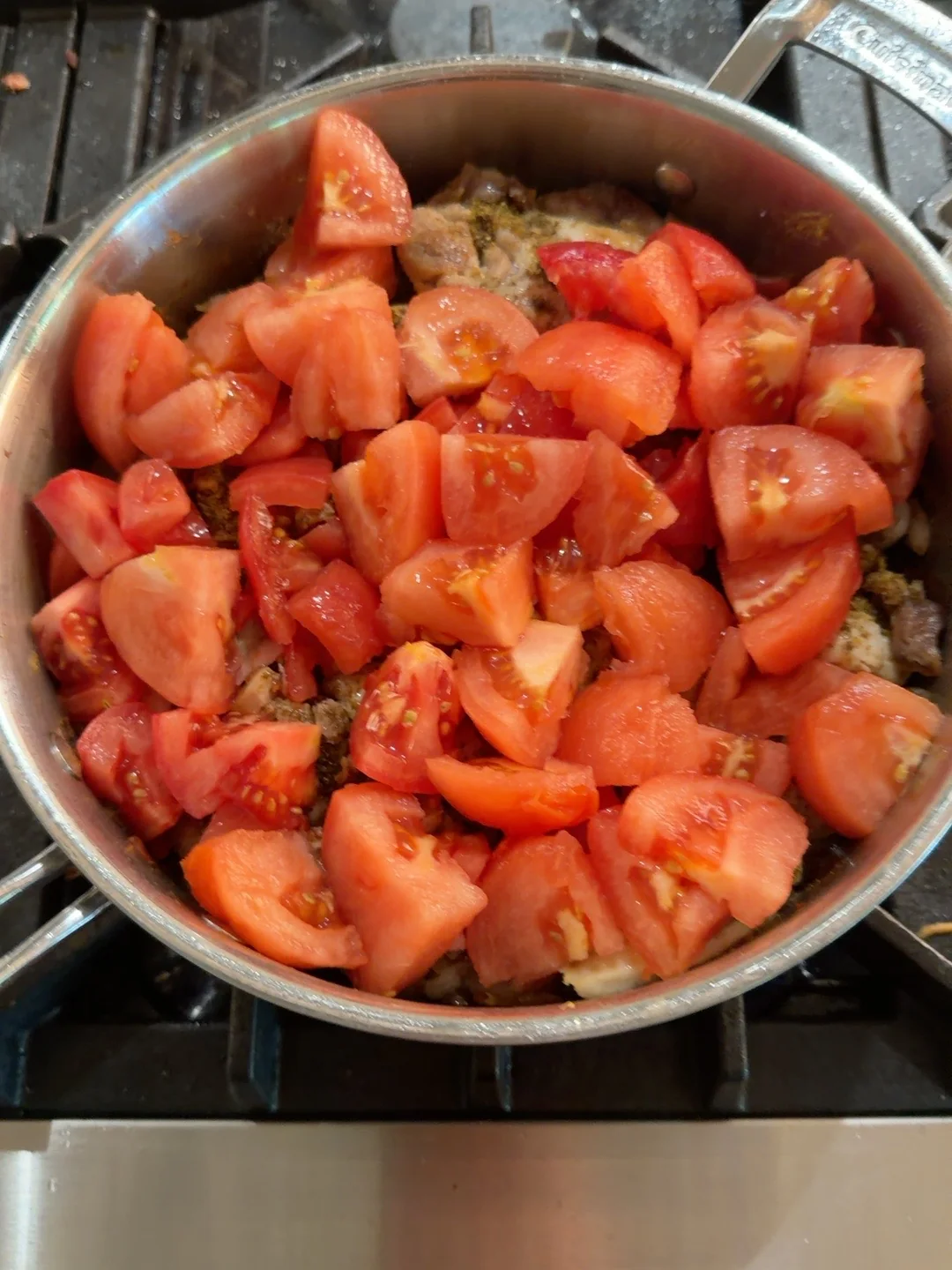 Peeled/chopped tomatoes added to the chicken.