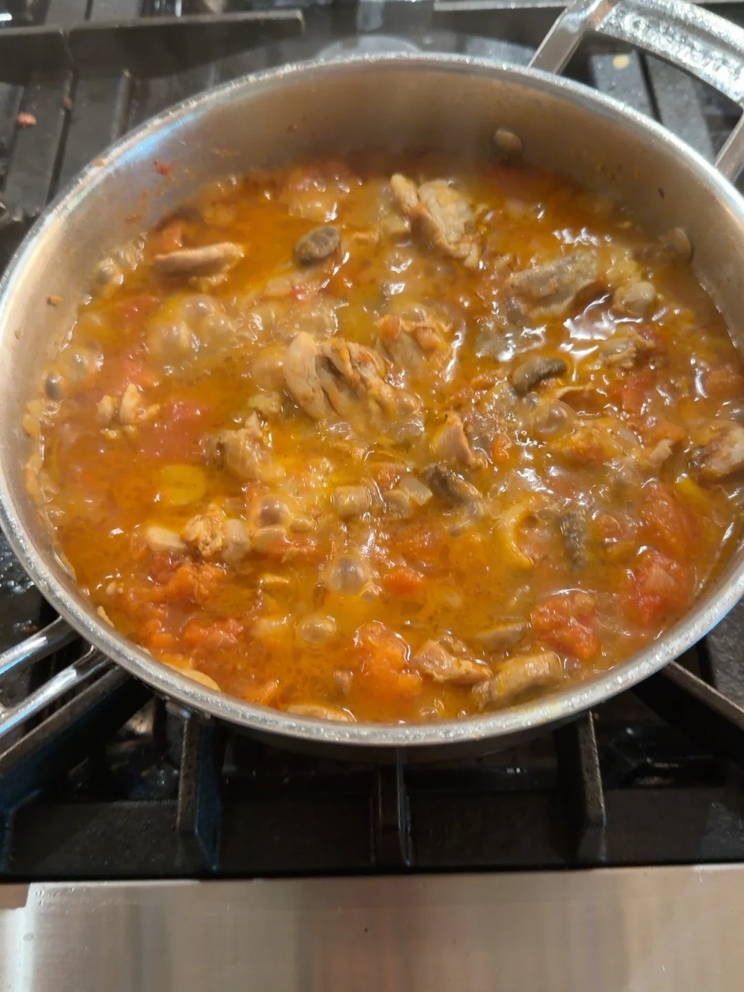 The sauce forming during the simmer.