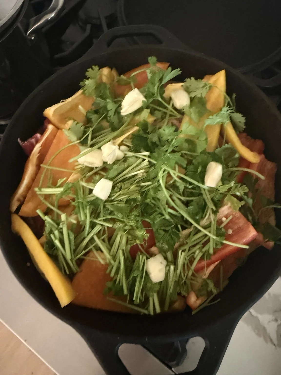 Peppers, herbs and garlic packed over the meat.